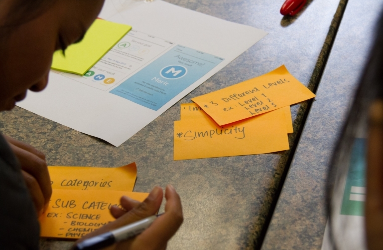 Post-it notes and paper prototype from a co-design workshop